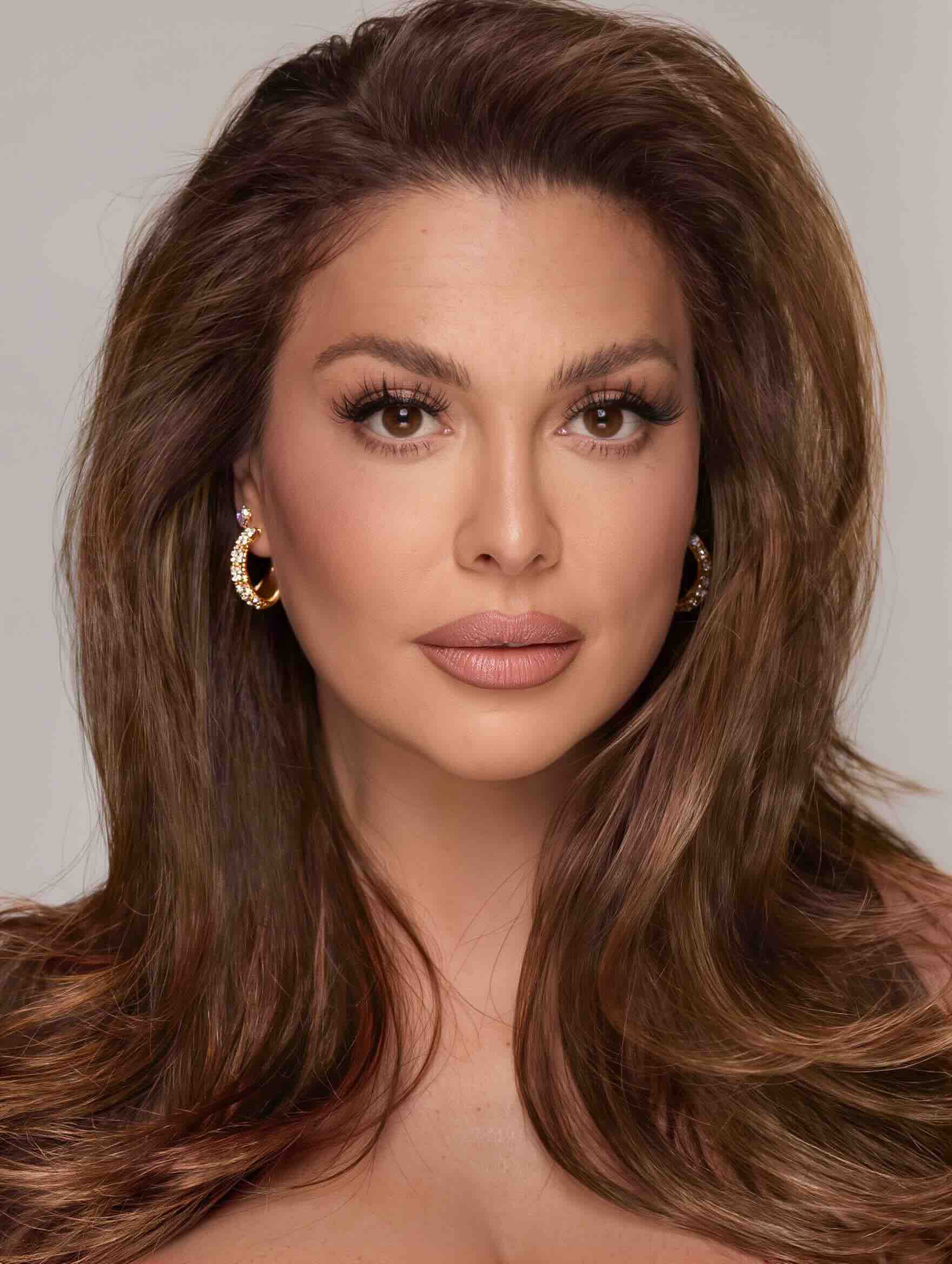 Long layered haircut with face-framing pieces for a plus-size woman over 40