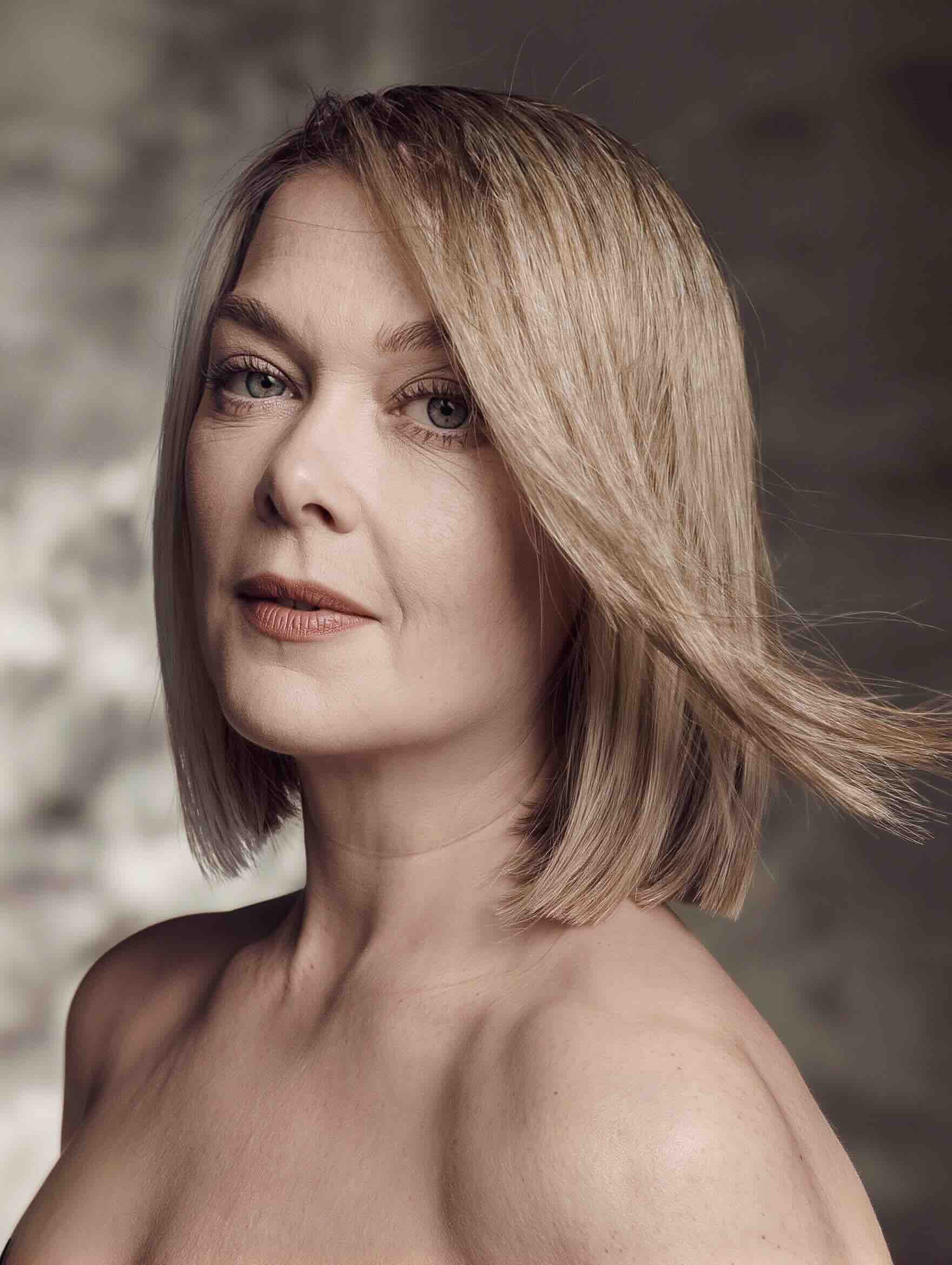 Sleek shoulder-length haircut with subtle layers for a plus-size woman over 40