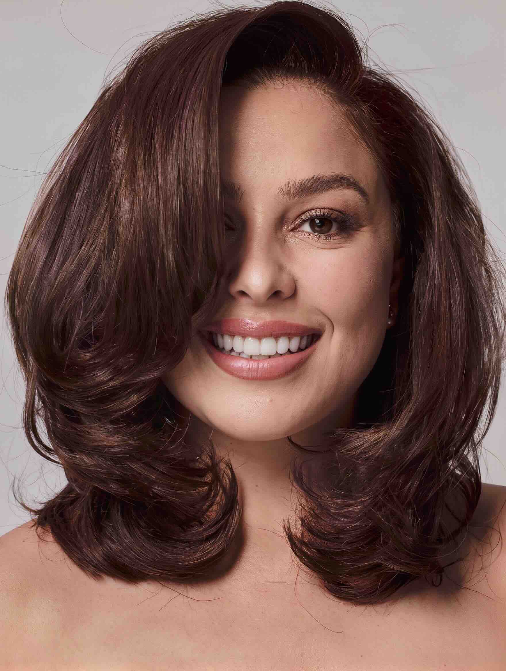Layered shoulder-length haircut for thick hair on a plus-size woman over 40