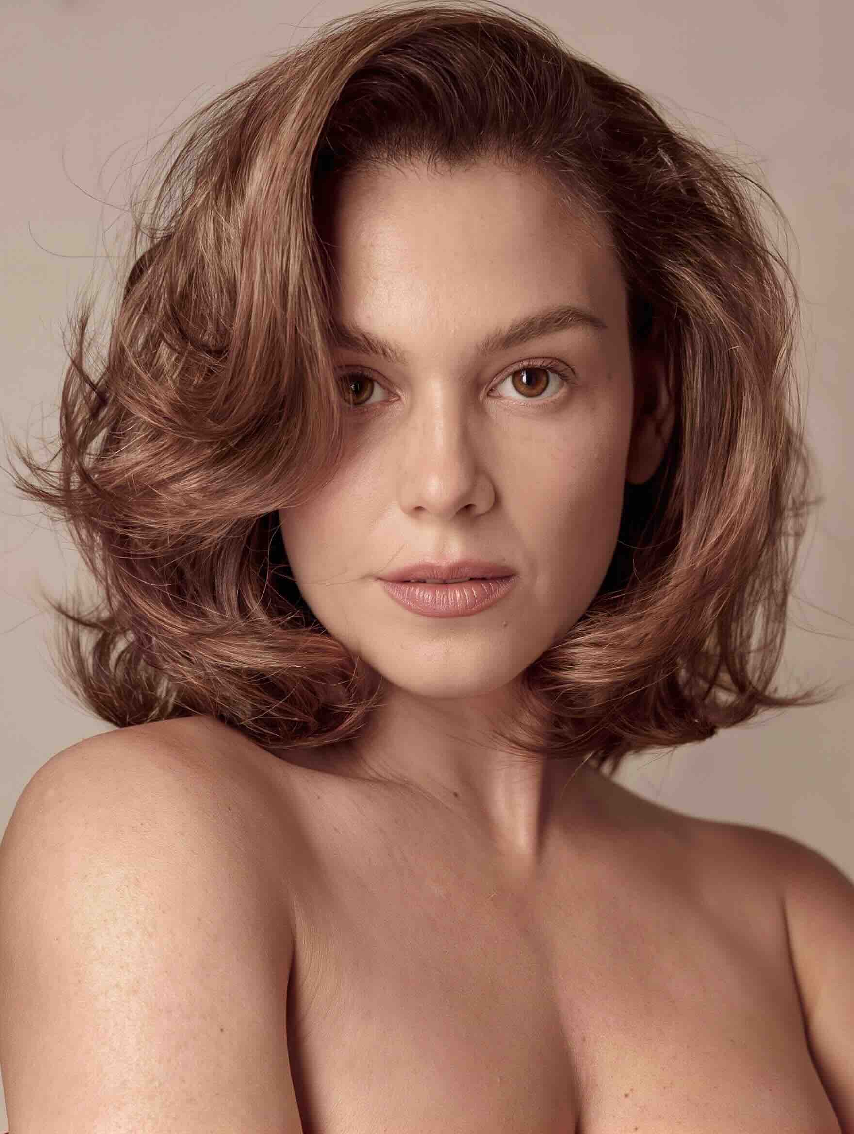 Medium-length layered haircut with face-framing pieces for a plus-size woman over 40